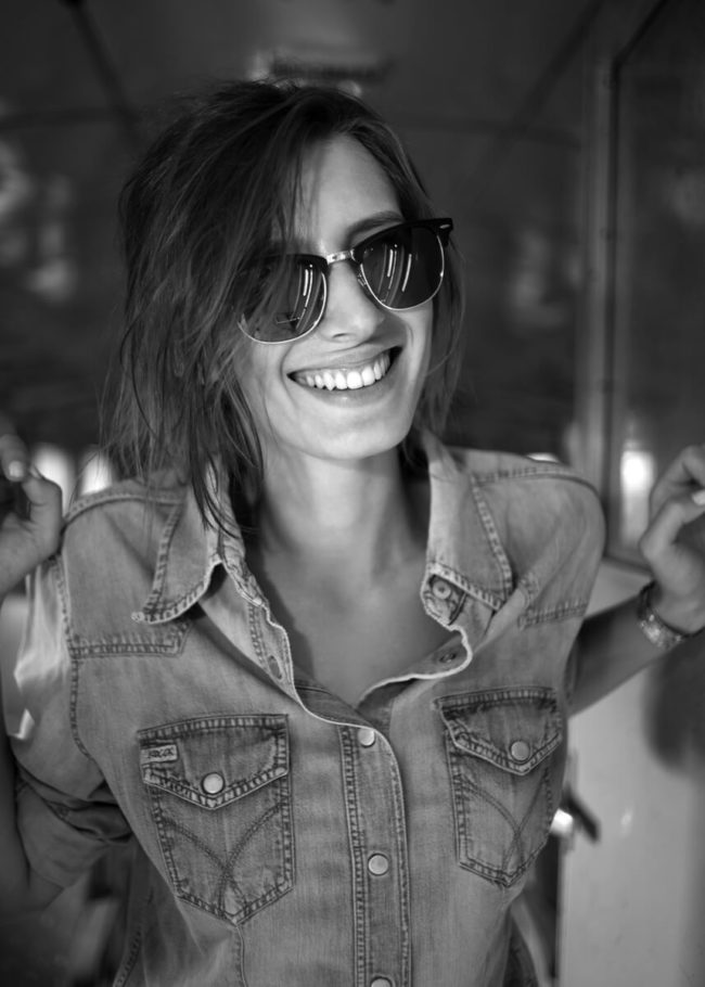 black and white photo of a young girl who laughs very happily