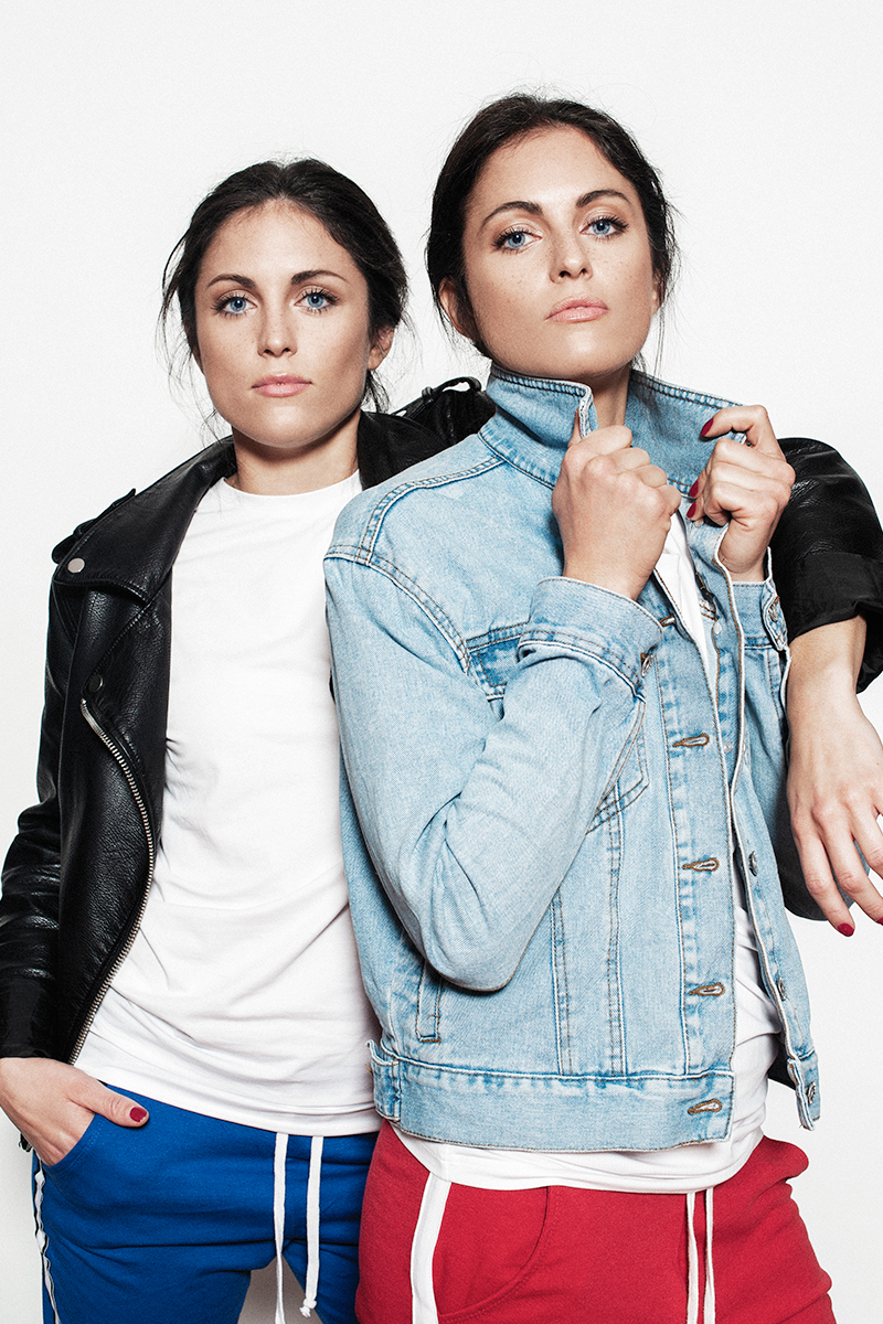 Italian twin sisters wearing white shirts and jeans and leather jackets