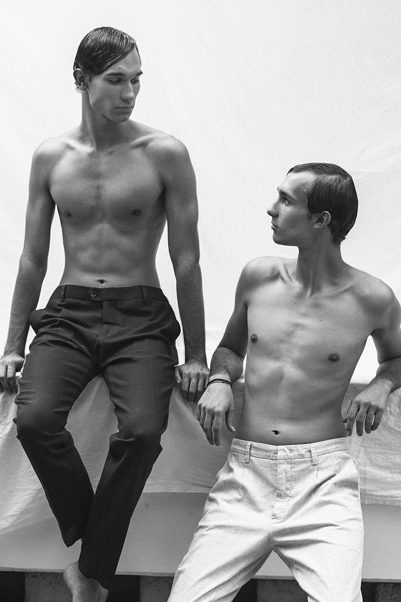 two half-naked Italian twins looking at each other