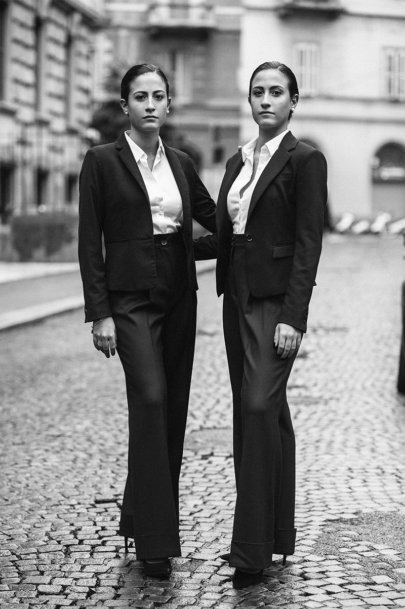 black and white photo of two Italian twins in very elegant dresses