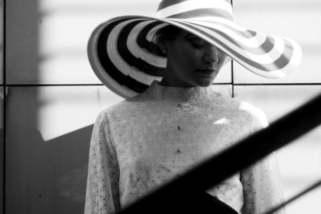 black and white photo of a very elegant girl with a very wide hair