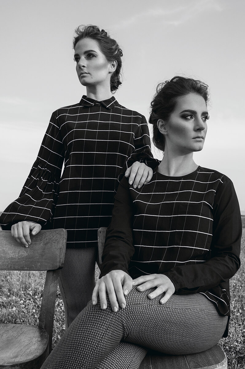 French twin sisters wearing checkered black shirts
